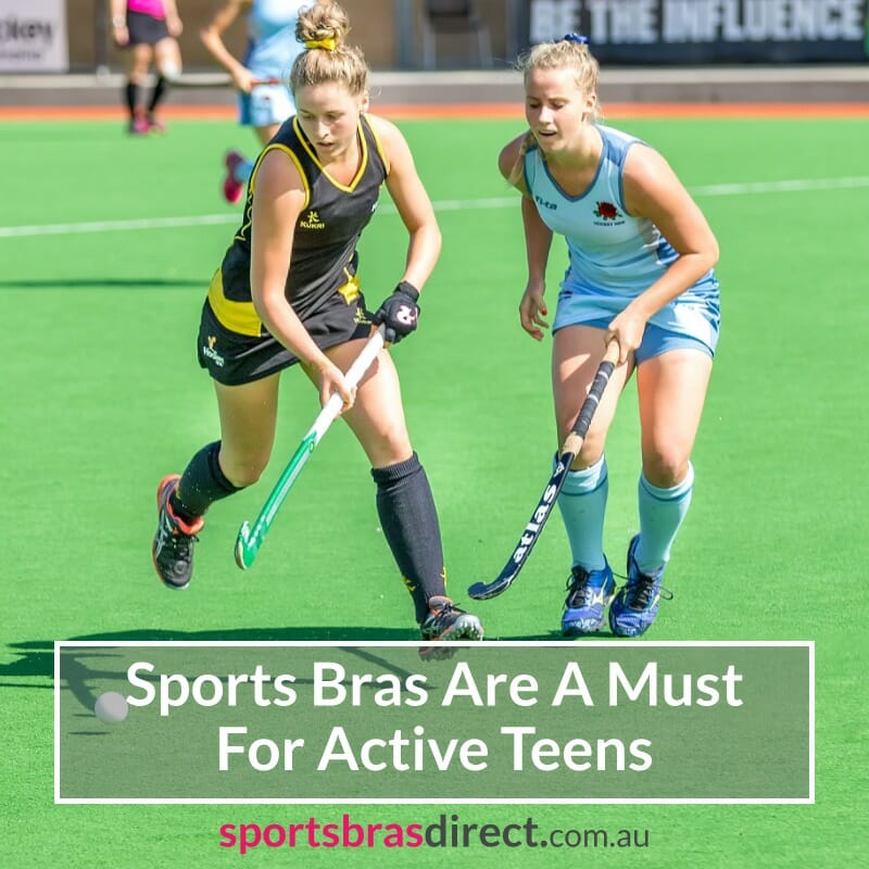 Two teenagers playing field hockey.