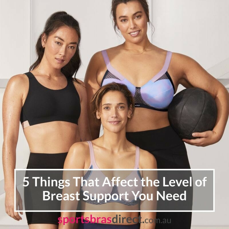 Three women wearing sports bras standing together.