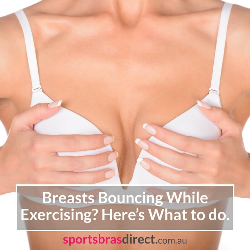 Woman in a White bra holding her breasts.