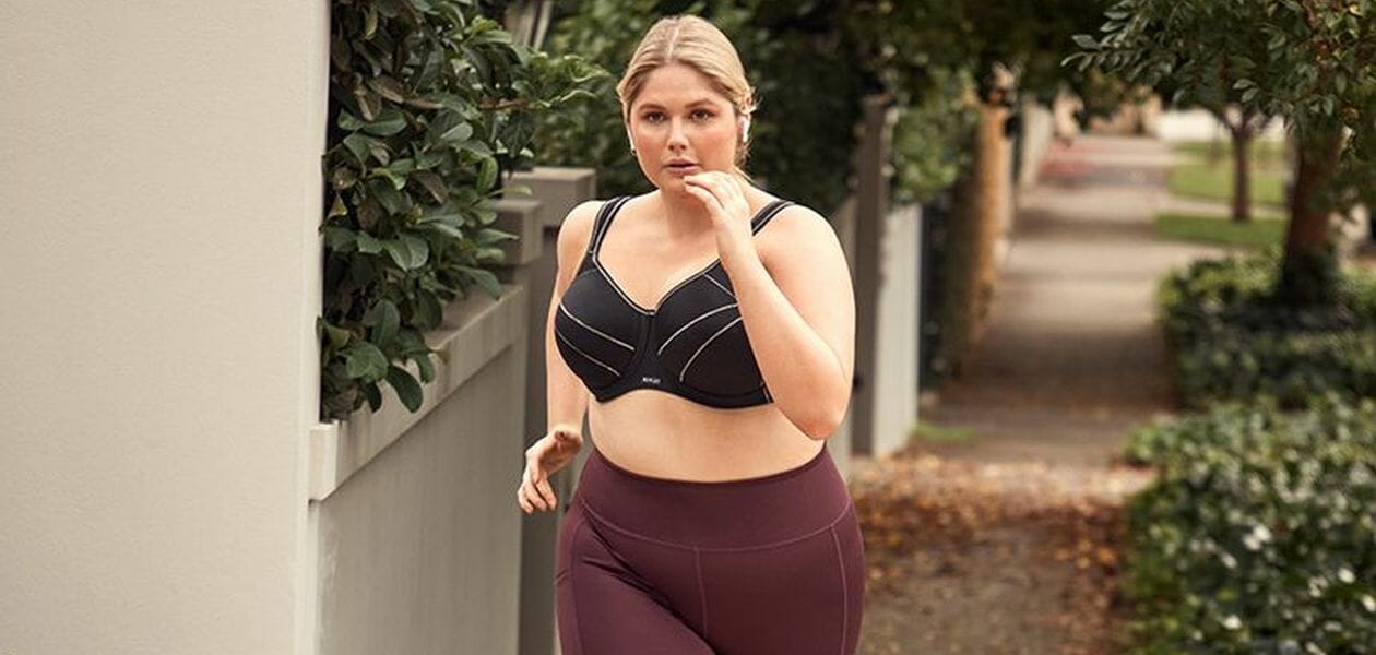 Woman running in a Black sports bra.