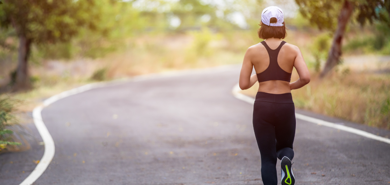 Rear view of woman wearing a black sports when running