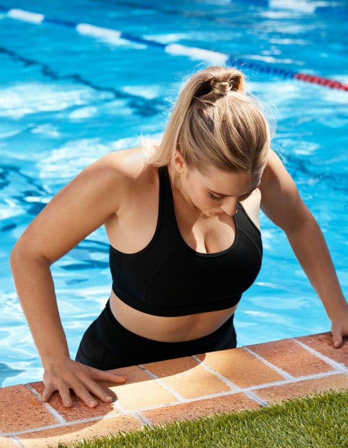 Woman getting out of swimming pool