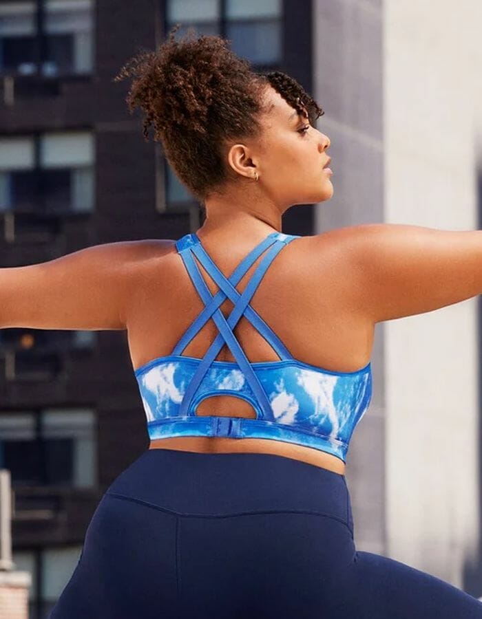 Women stretching in a blue pattern sports bra