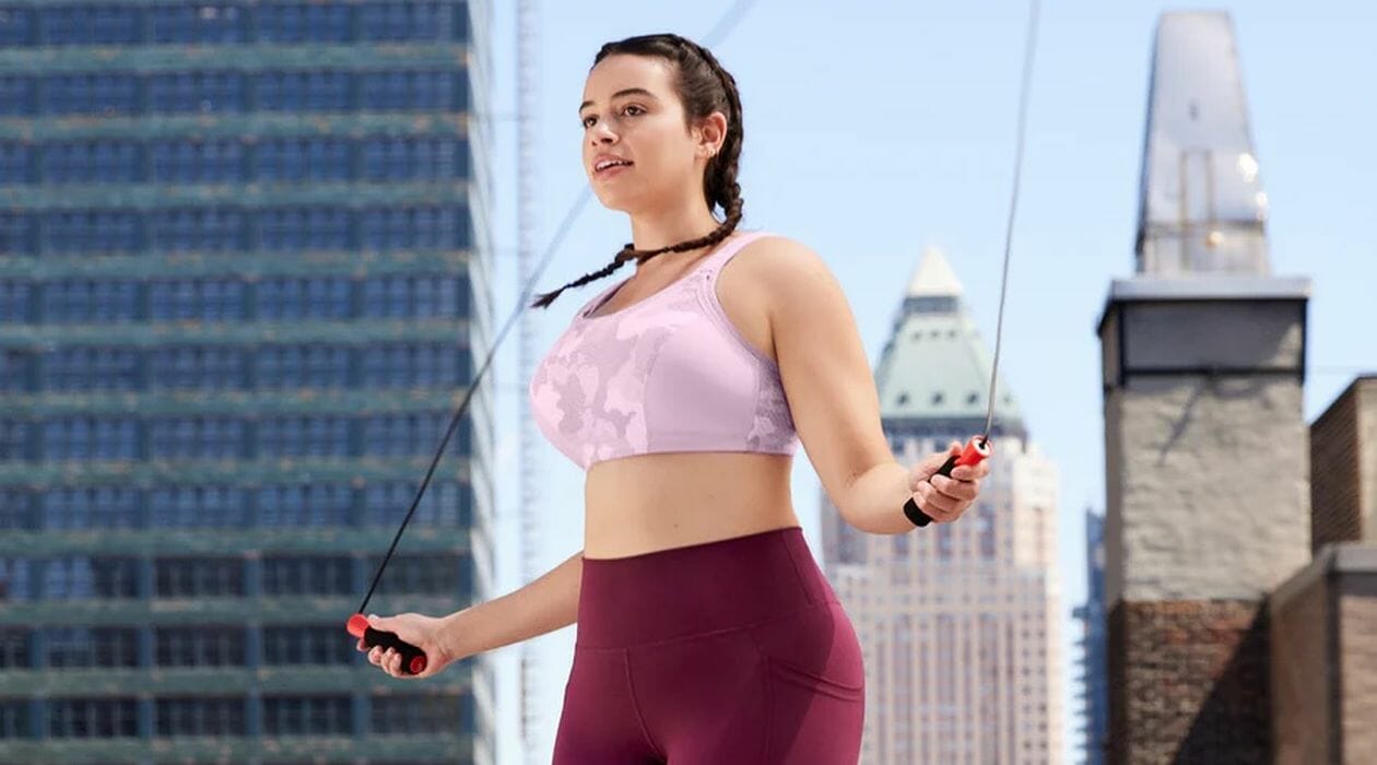 Woman in a pink sports bra skipping.