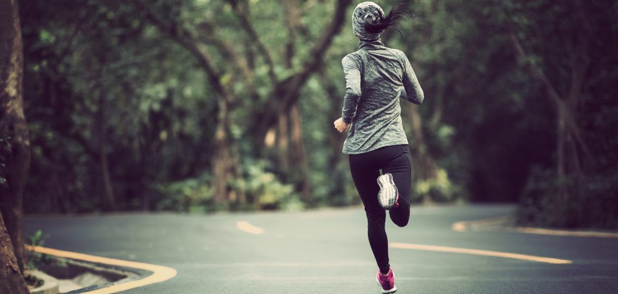 Woman road running in the cold.