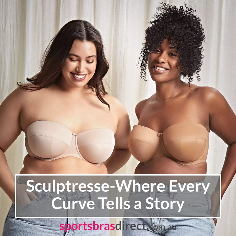 Two women wearing sports bras laughing.