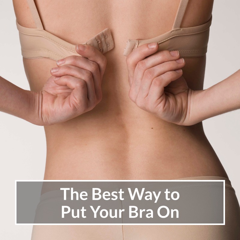 Woman doing her Nude coloured bra up at the back.
