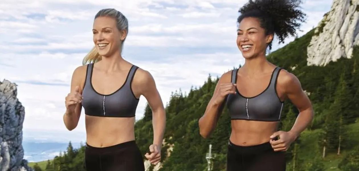Two women running in sports bras.
