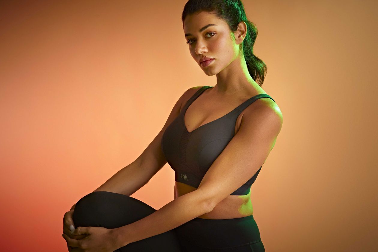 Woman sitting confidently in a sports bra.